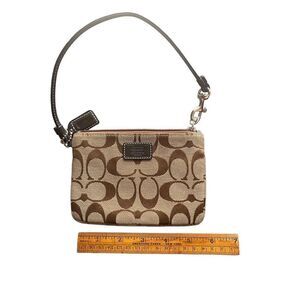 Coach Corner Zip in Signature Canvas
Coach tan brown trim